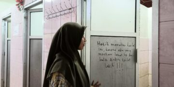 Salah seorang mahasiswi Unand memasuki toilet wanita tempat terjadinya kasus perekaman di Masjid Nurul Ilmi.