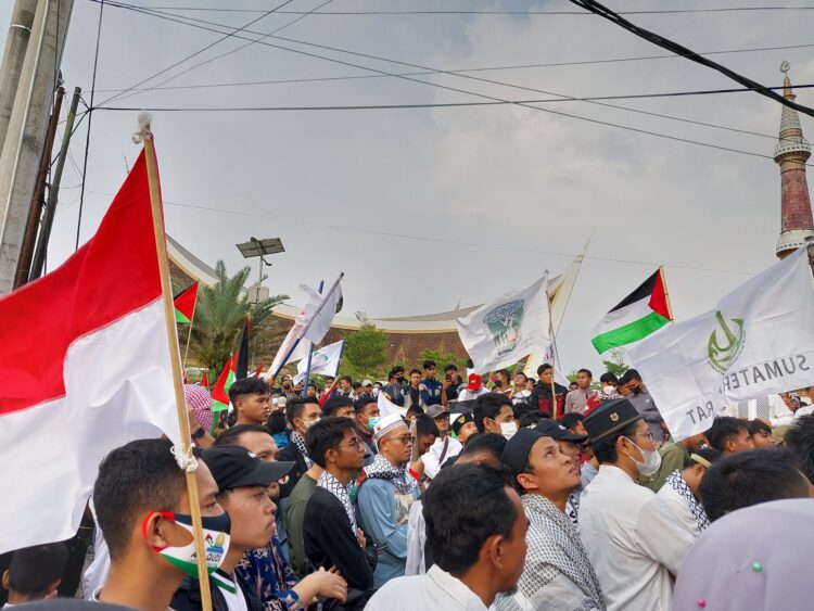 Massa melakukan aksi solidaritas peduli palestina di depan Masjid Raya Sumbar pada Minggu (15/10/2023) (Genta Andalas/Fadhilatul Husni)